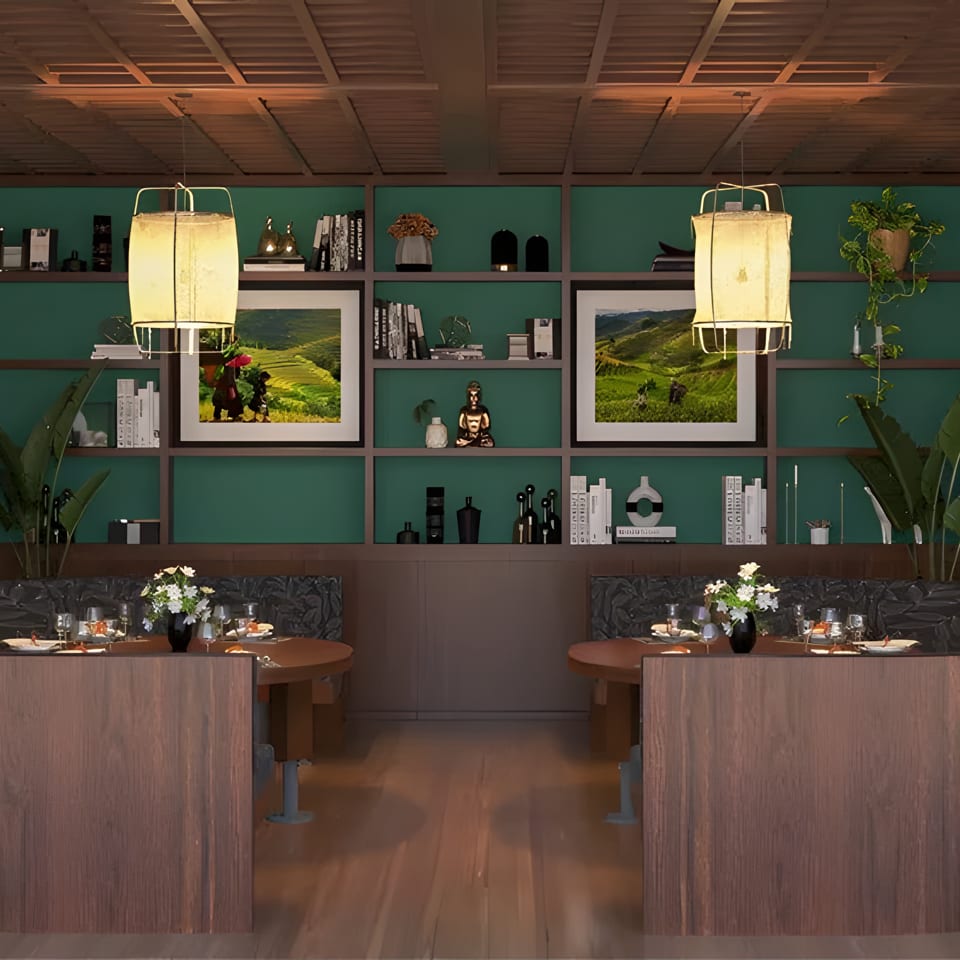 Restaurant interior with two circular booths, wooden tables, green shelving, and rice paddy murals.